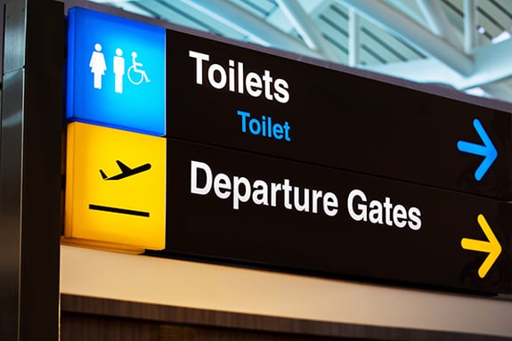 AdobeStock_86322068-airport-restroom-sign