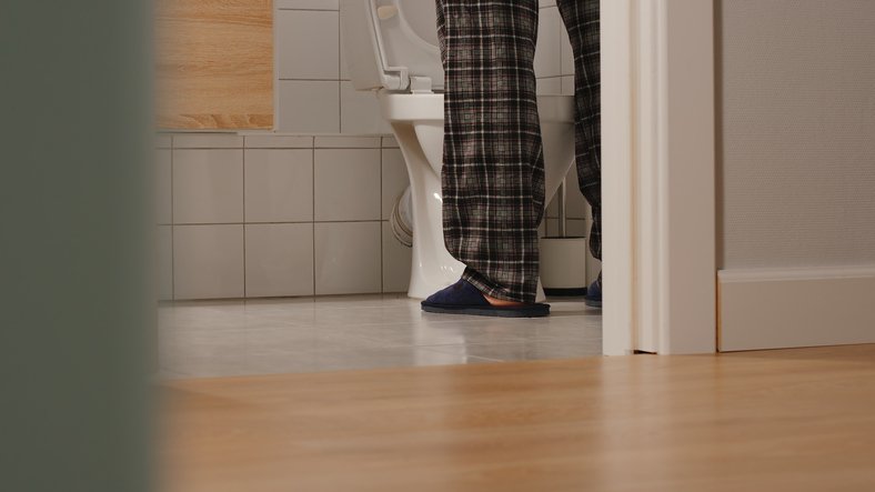man peeing again interrupting his night - frequent urination
