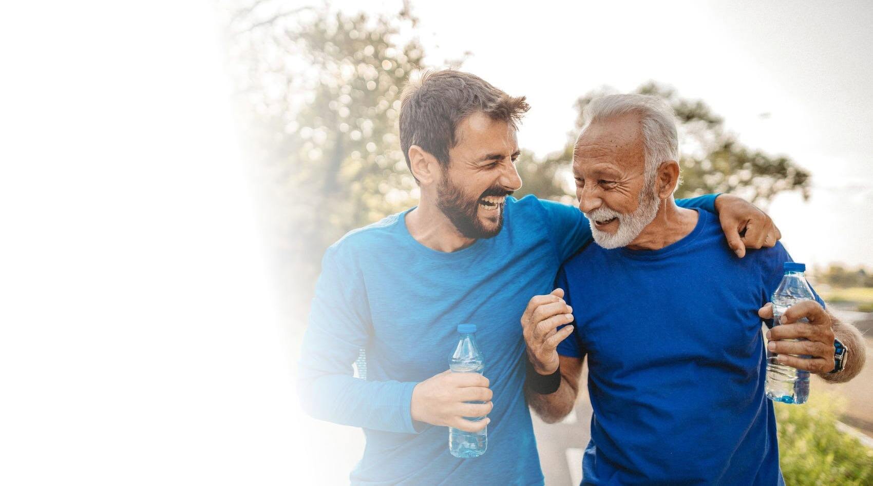 Two men hugging and laughing