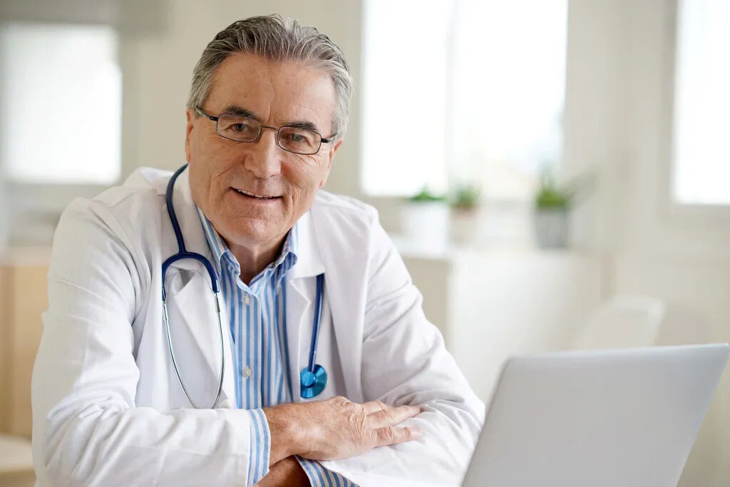 Doctor sitting in front of a laptop