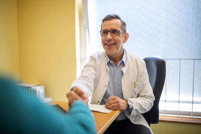 Doctor shaking hands with a patient