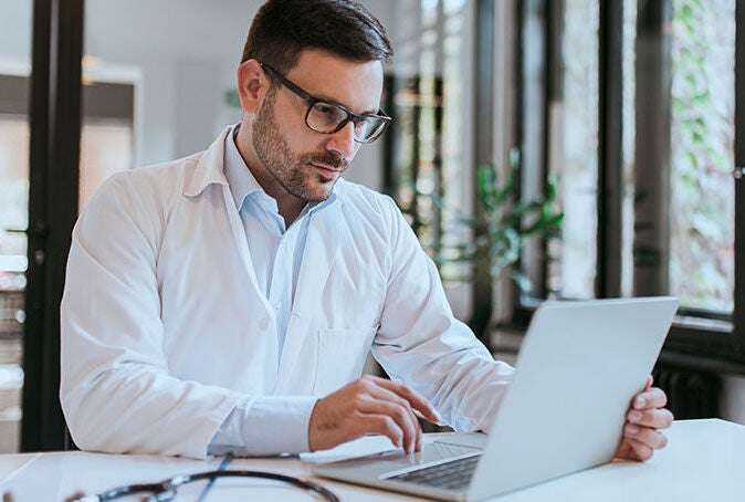 Doctor using a laptop