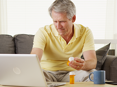 Man looking up BPH meds on computer